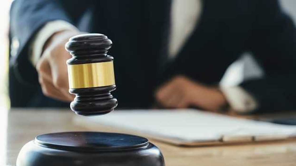 A judge with a wooden gavel in a courtroom