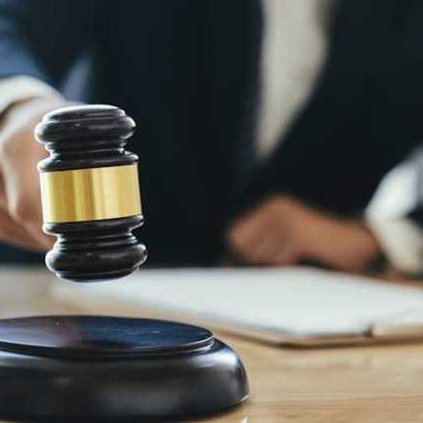 A judge with a wooden gavel in a courtroom