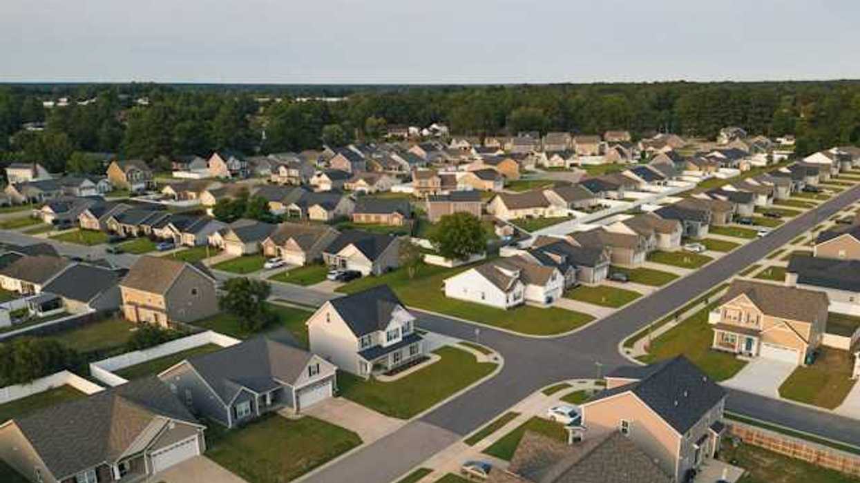 A laid out subdivision with white and tan houses