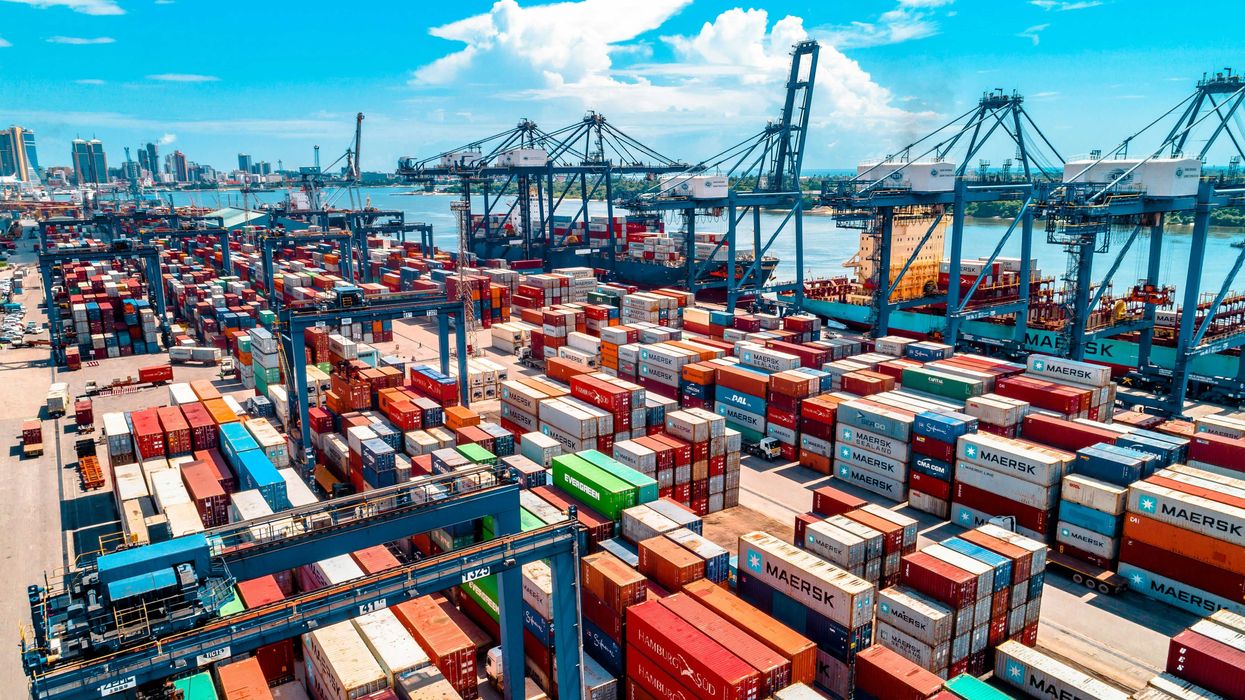 a large amount of containers are stacked on top of each other.