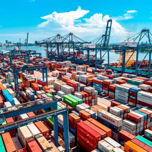 a large amount of containers are stacked on top of each other.