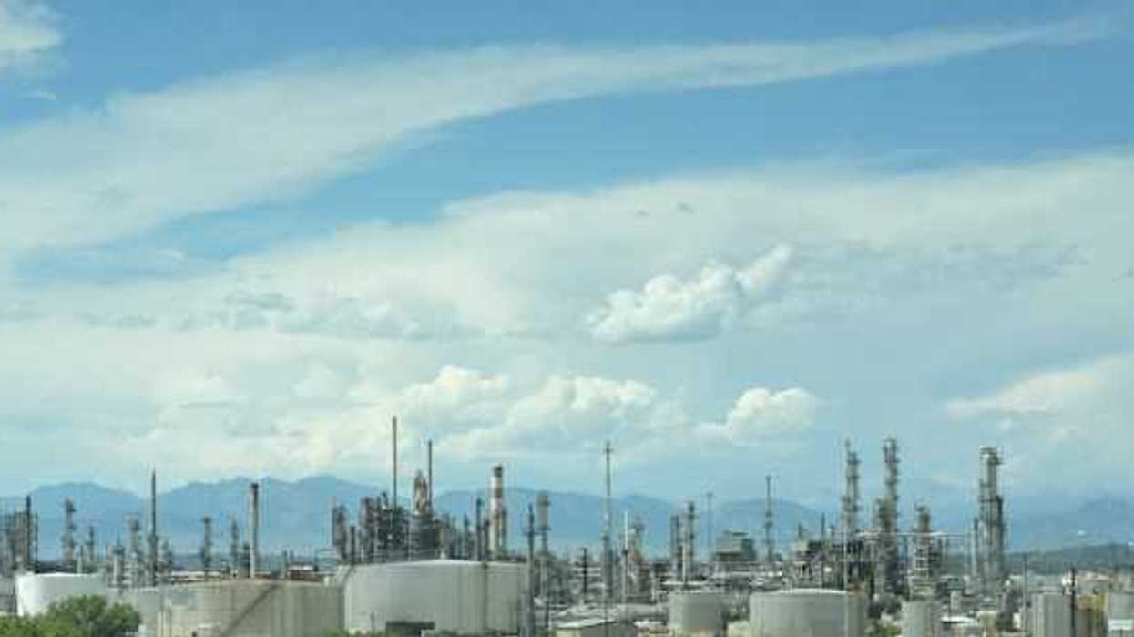 A large industrial area with smoke coming out of the stacks