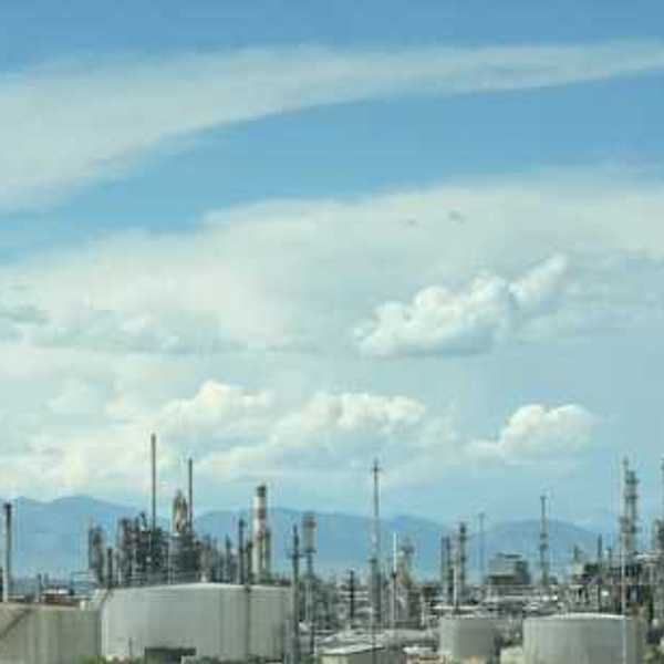 A large industrial area with smoke coming out of the stacks