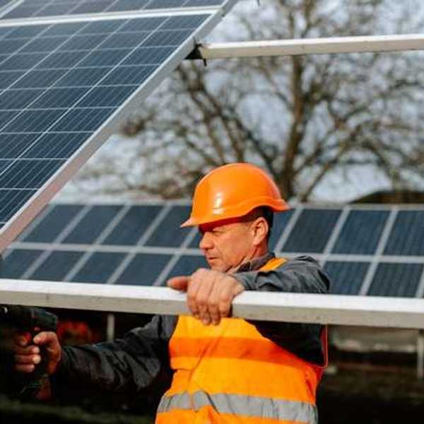 A maintenance worker installing solar panels