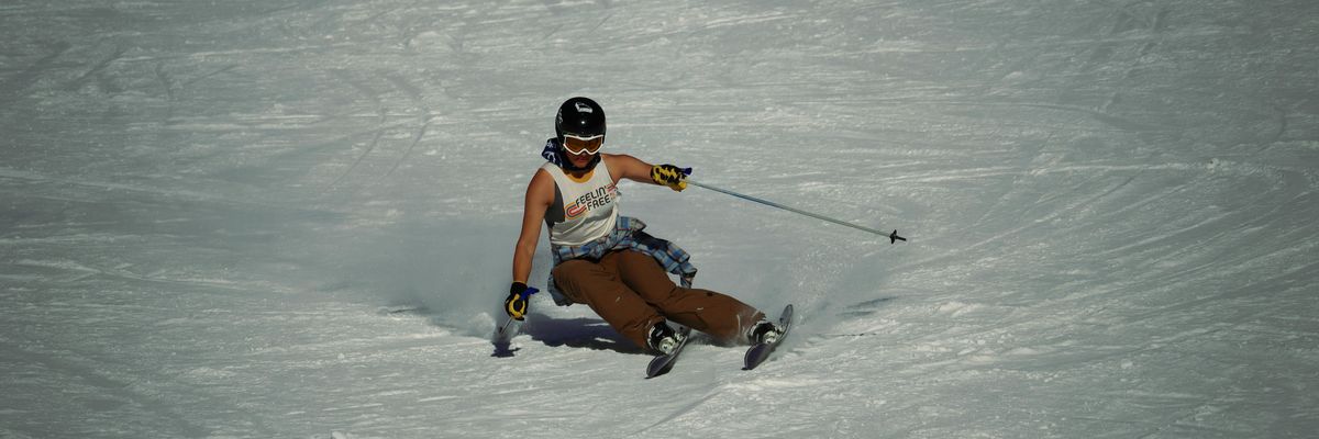 a man riding skis down a snow covered slope.