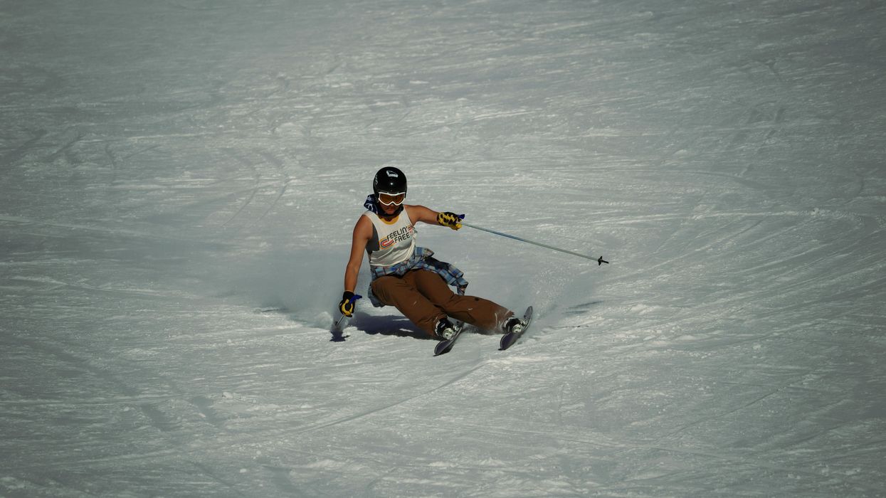 a man riding skis down a snow covered slope.