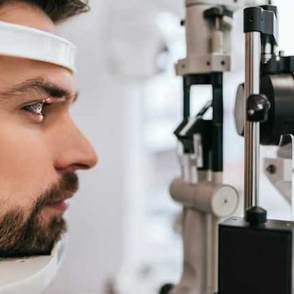 A man's head being viewed in an ophthalmology machine