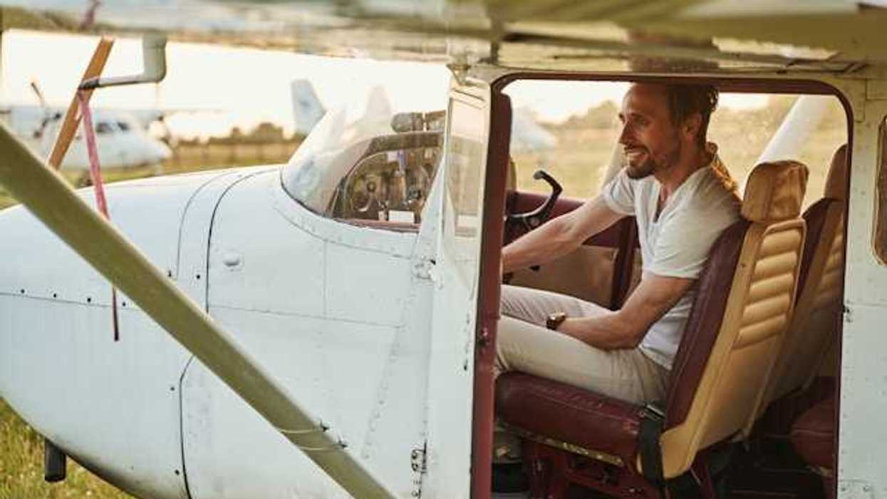 A man sitting in a small white airplane