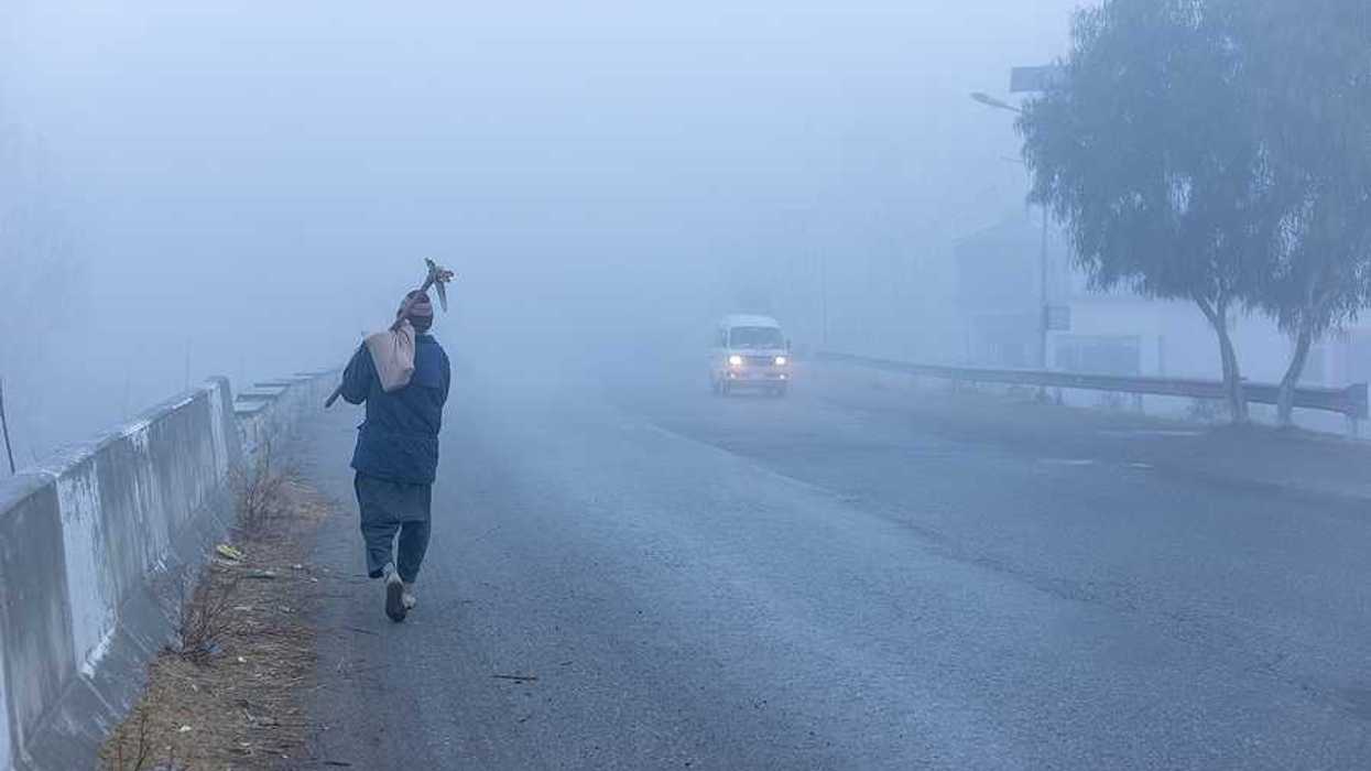 A man walking through thick air on his way to work in the morning