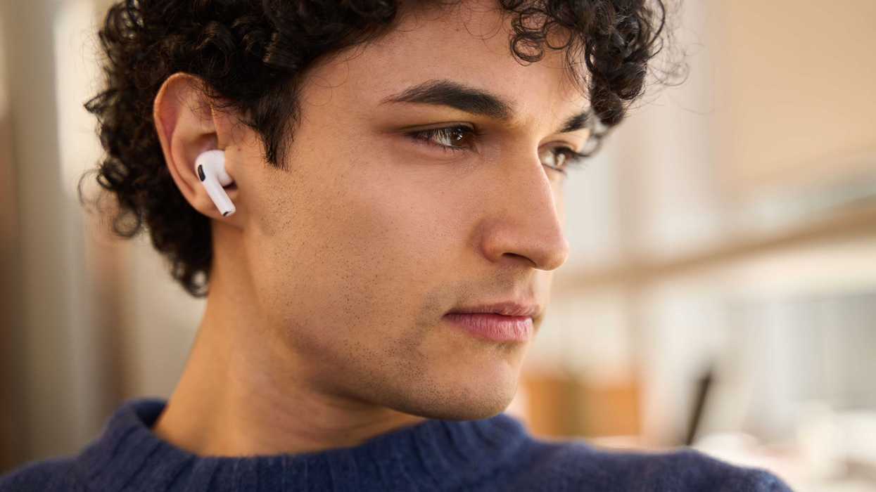 A man wears bluetooth wireless headphones