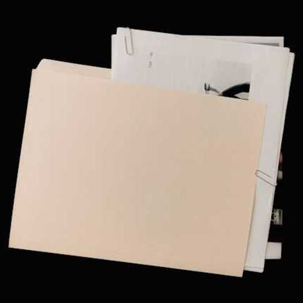 A manila folder covering a pile of documents