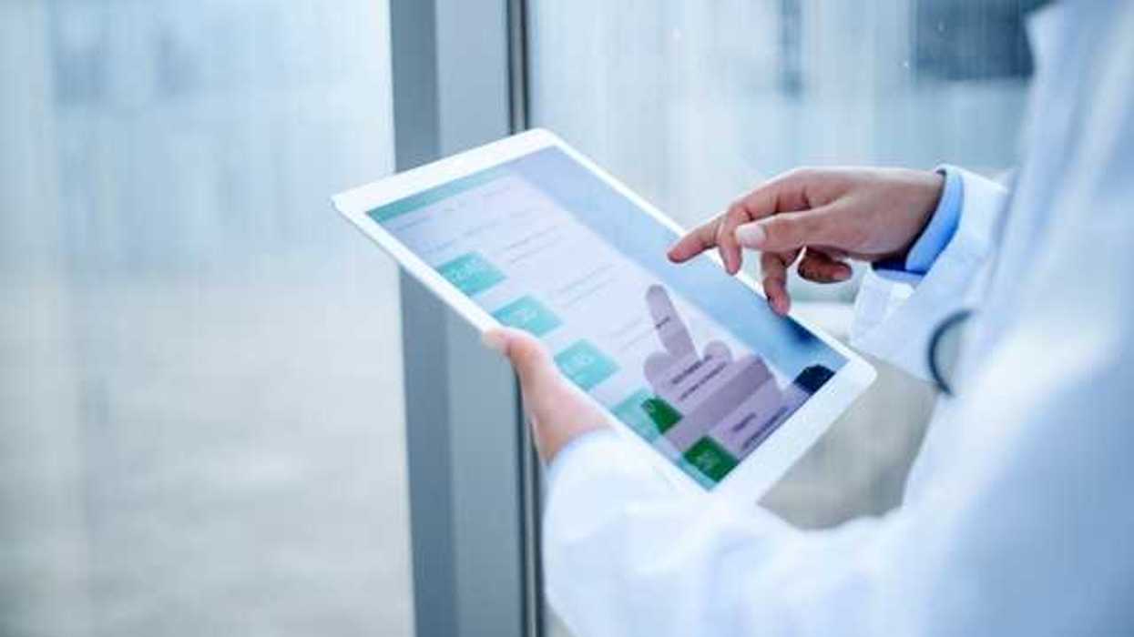 A medical professional holding a tablet