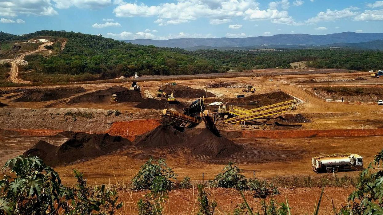 a mining site with a large amount of dirt in the foreground.