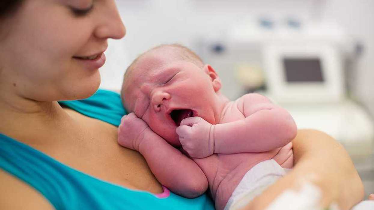 A mother holding a newborn baby