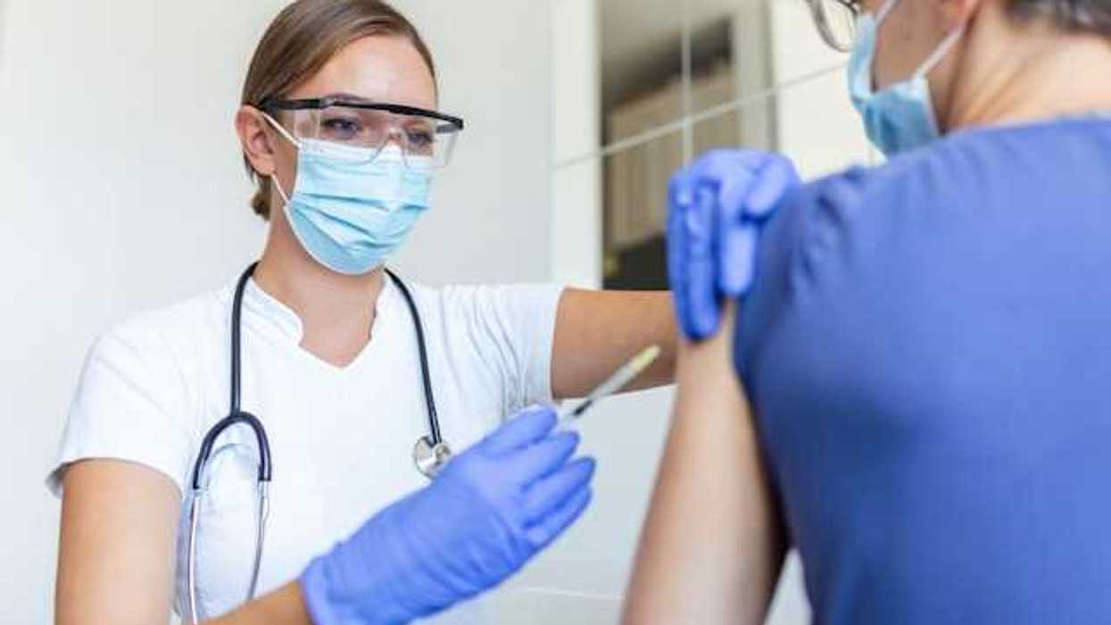 A nurse giving a patient a vaccination