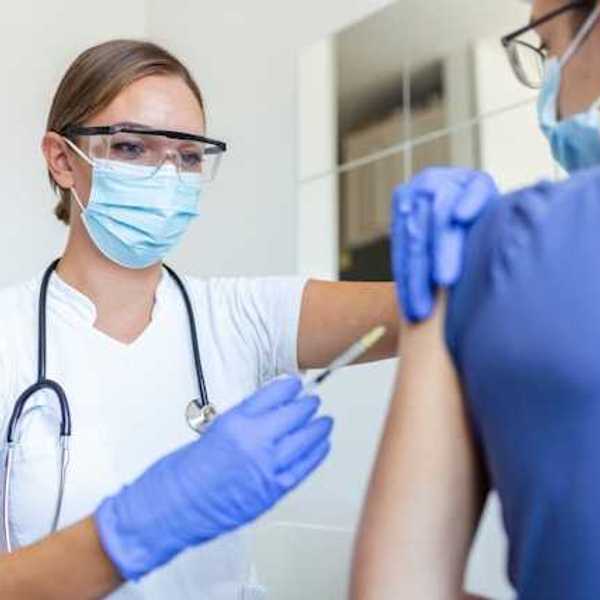 A nurse giving a patient a vaccination
