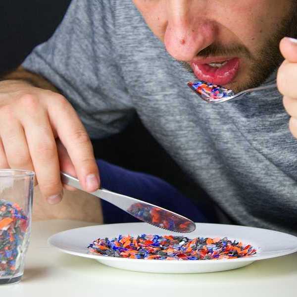 A person eating microplastics off a plate