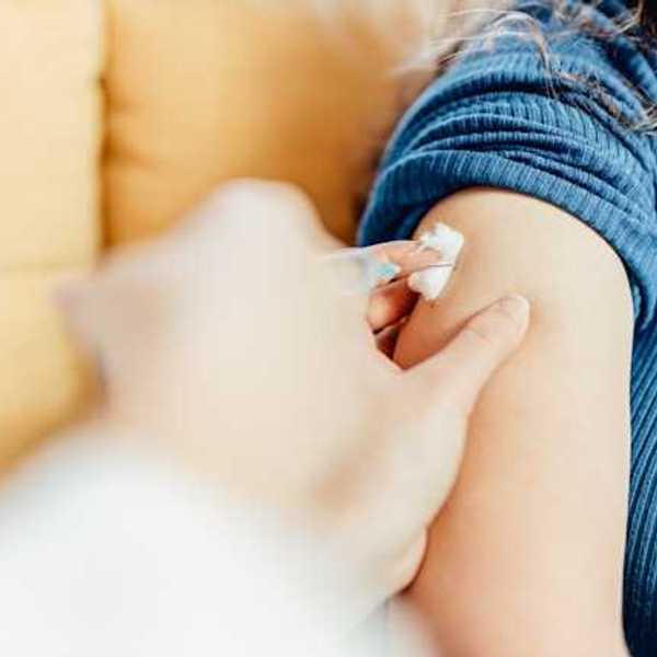 A person having a vaccination in their upper arm