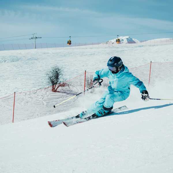 a person on skis going down a snowy hill.