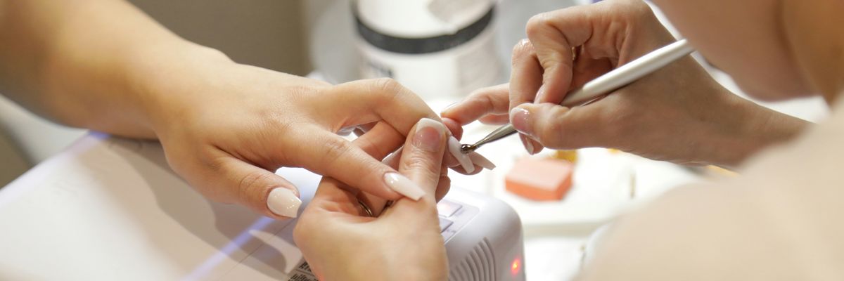 A person receives a manicure at the salon