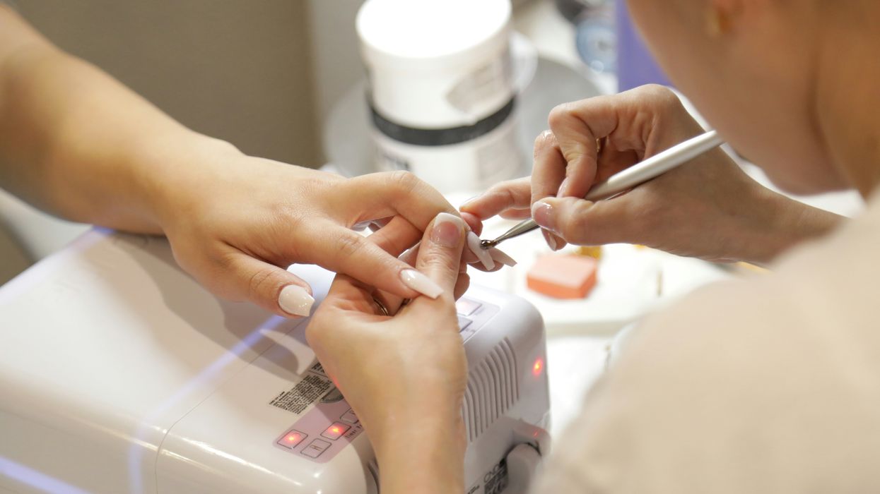 A person receives a manicure at the salon