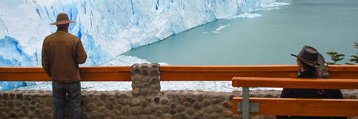 A person standing at a viewing platform of the Perito Moreno Glacier in Argentina.