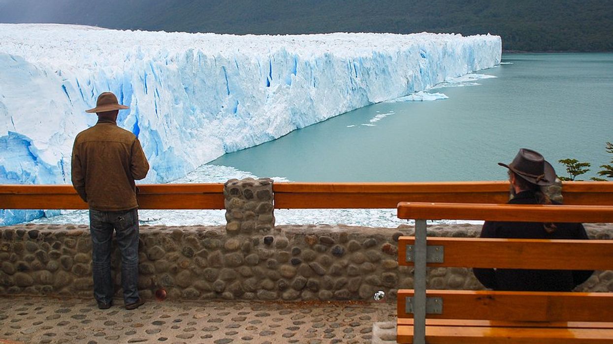A person standing at a viewing platform of the Perito Moreno Glacier in Argentina.
