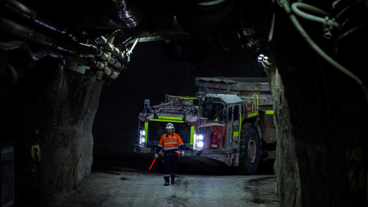 A person standing in a mining tunnel.