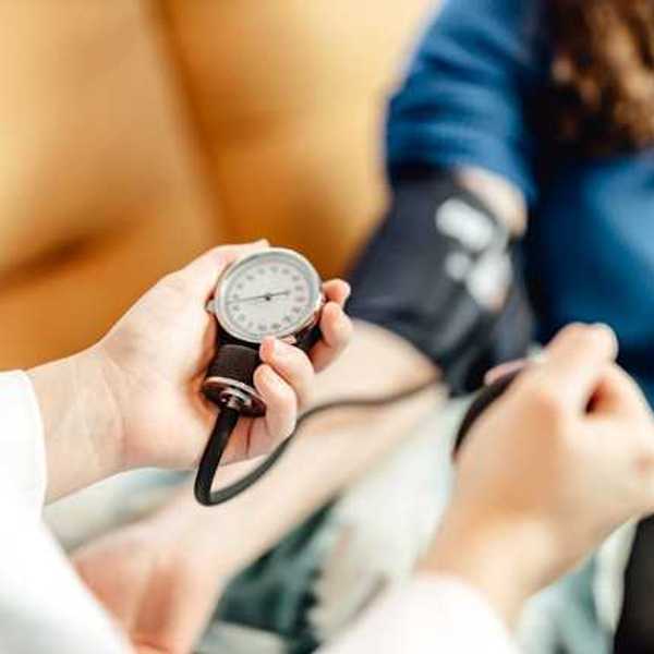 A person taking a patient's blood pressure