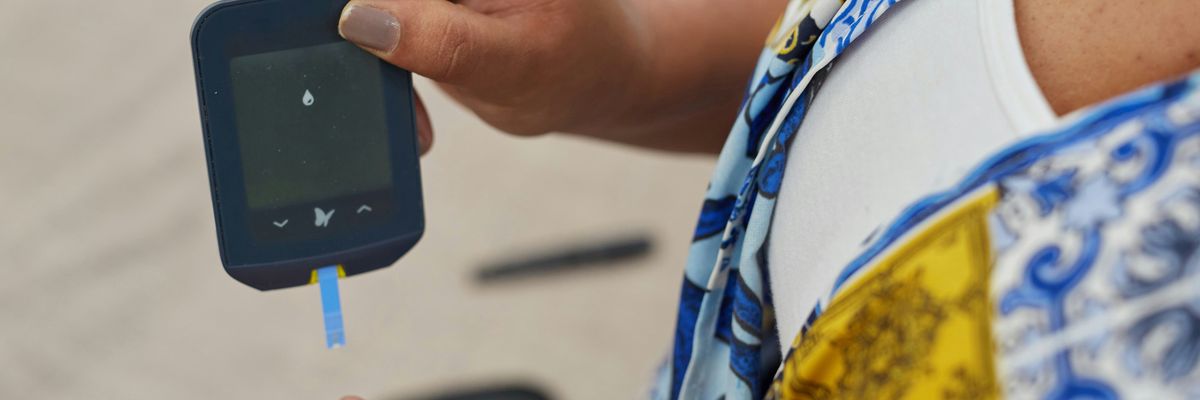 a person using a gluco-meter