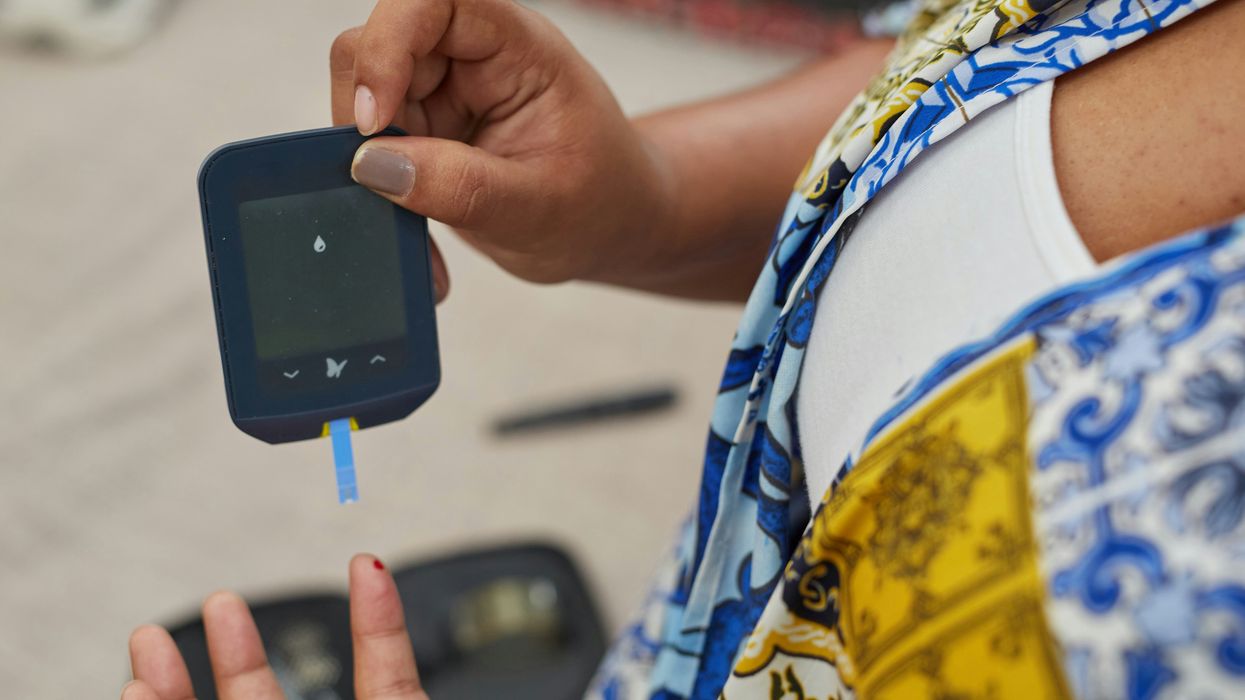 a person using a gluco-meter