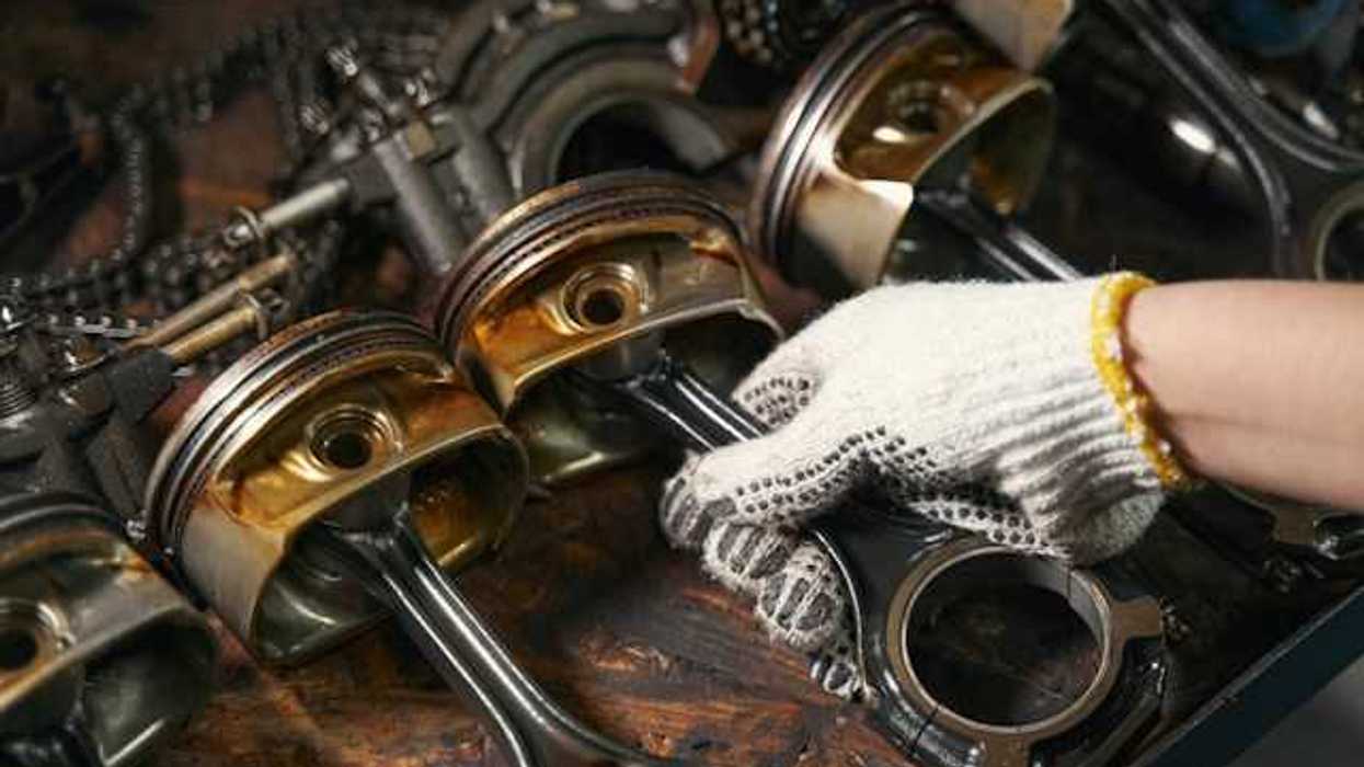 A person working on a car engine