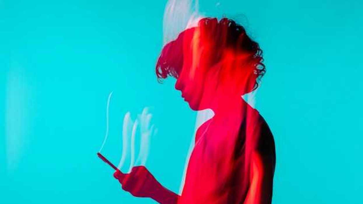A photo of a child holding a smart phone