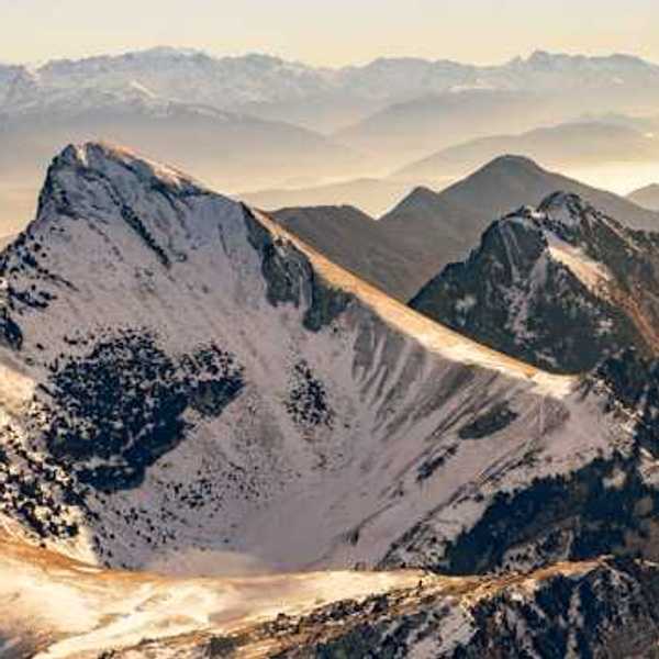 A photo of snow-capped French alps during the golden hour
