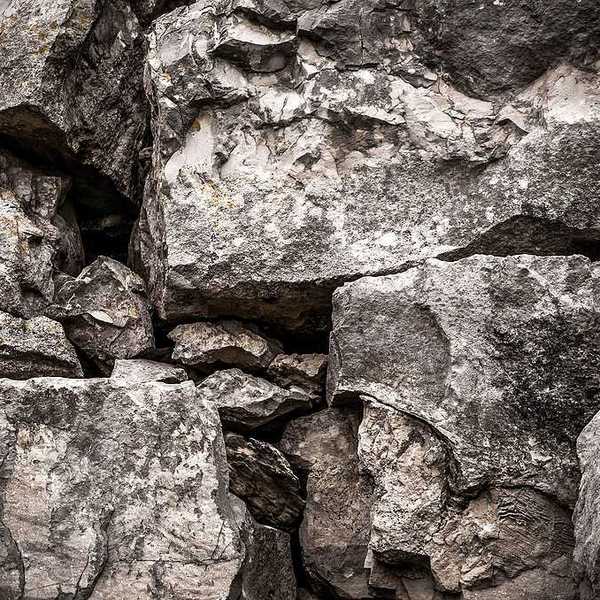 A pile of boulders in a black and white photo