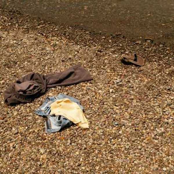 A pile of clothing on a rocky beach