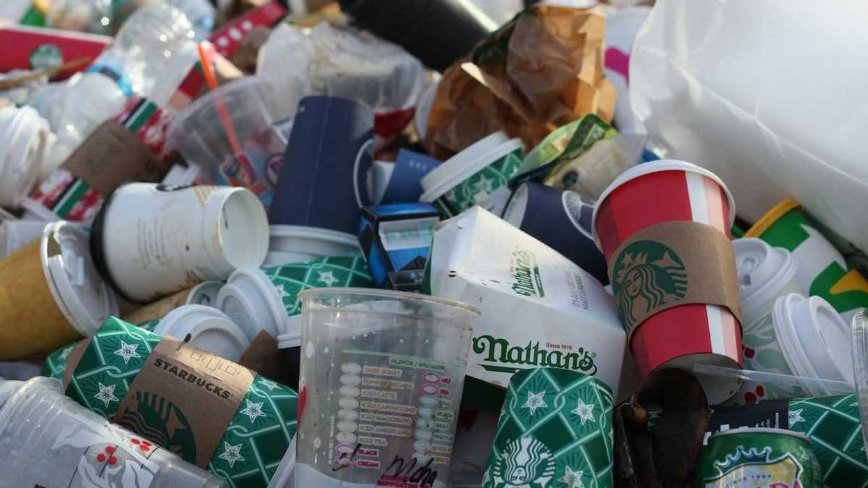 A pile of coffee-to-go cups and takeout packaging