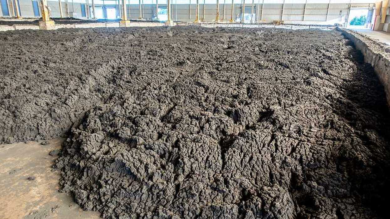 A pile of farm sludge collected in a barn