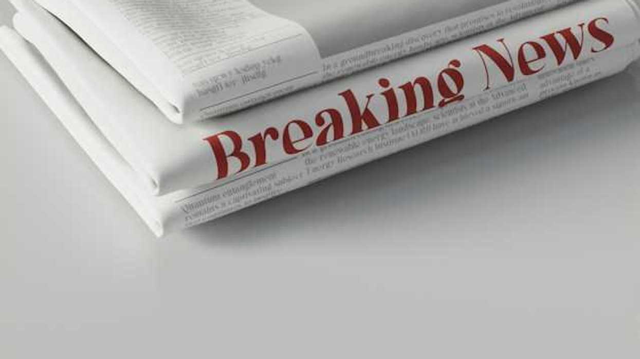 A pile of newspapers with the words Breaking News in red