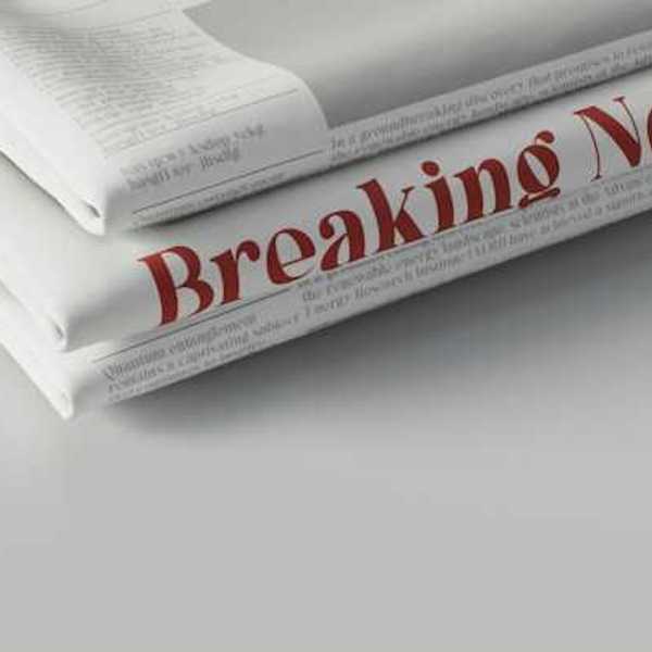 A pile of newspapers with the words Breaking News in red