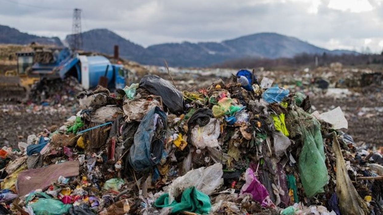A pile of plastic waste and other trash in a landfill