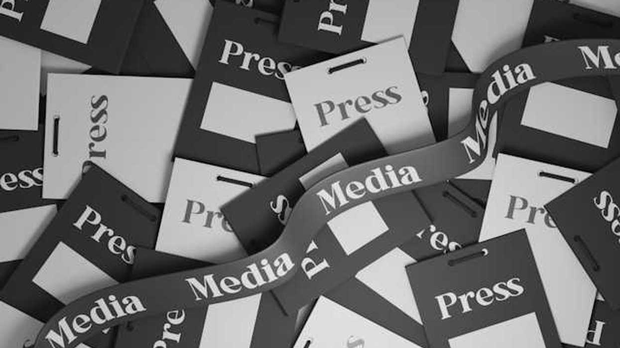 A pile of press passes in black and white