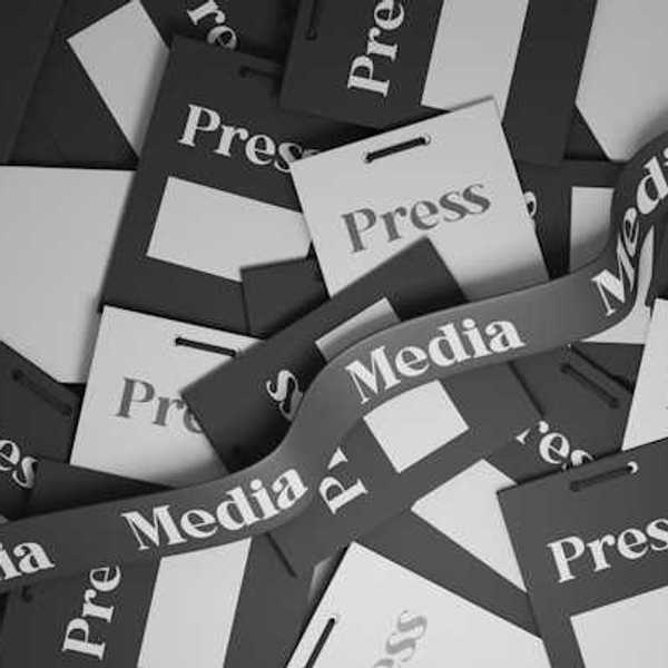 A pile of press passes in black and white