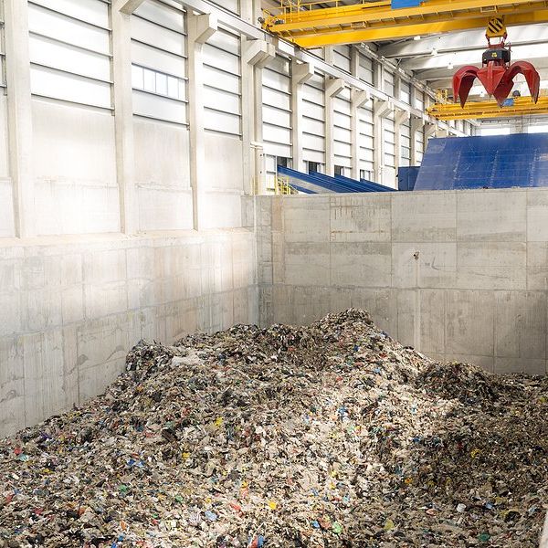A pile of shredded plastic material in a recycling facility.