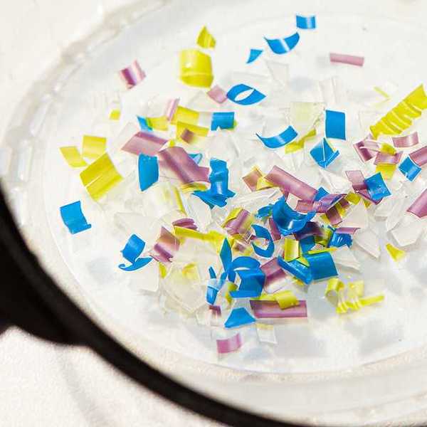 A pile of small pieces of multicolored plastic under a microscope