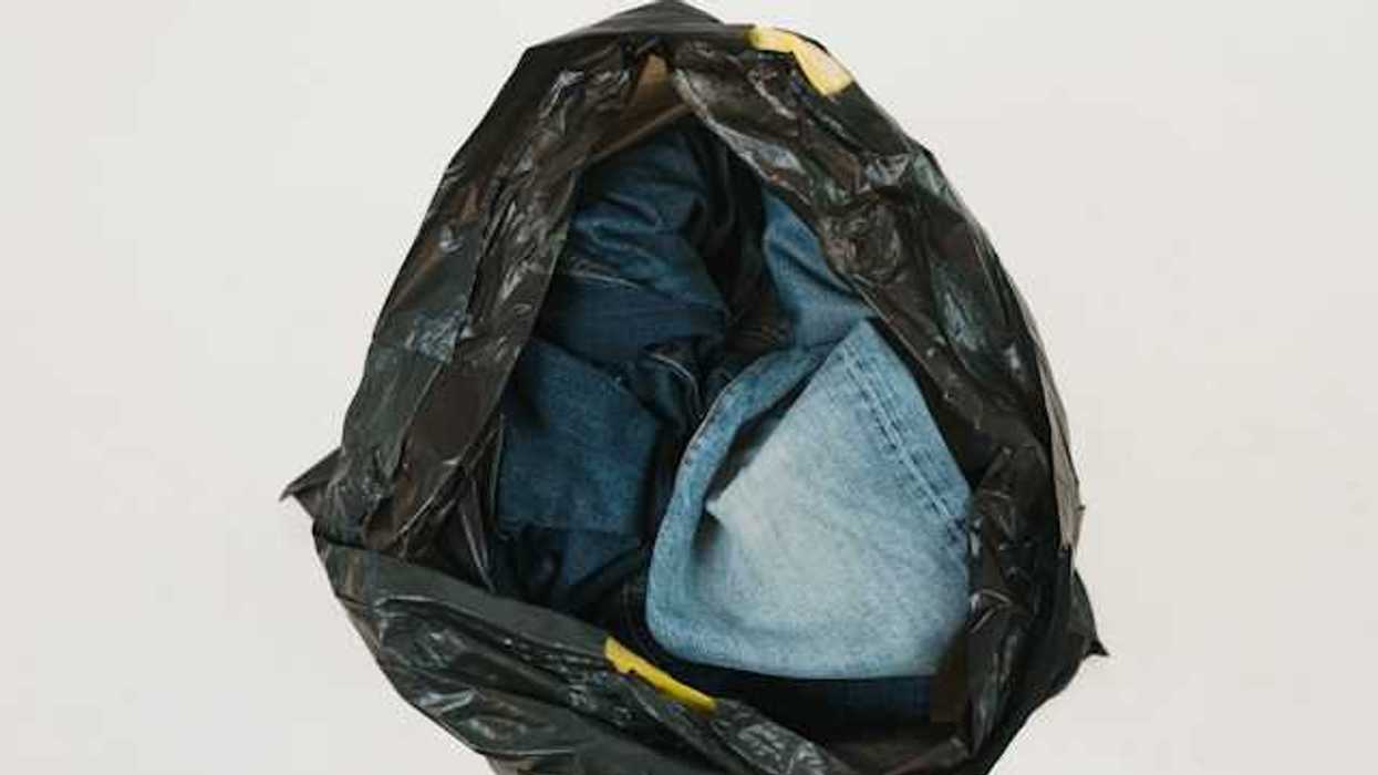 A plastic bag filled with old denim jeans