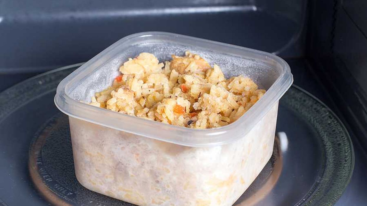 A plastic food container sitting in a microwave