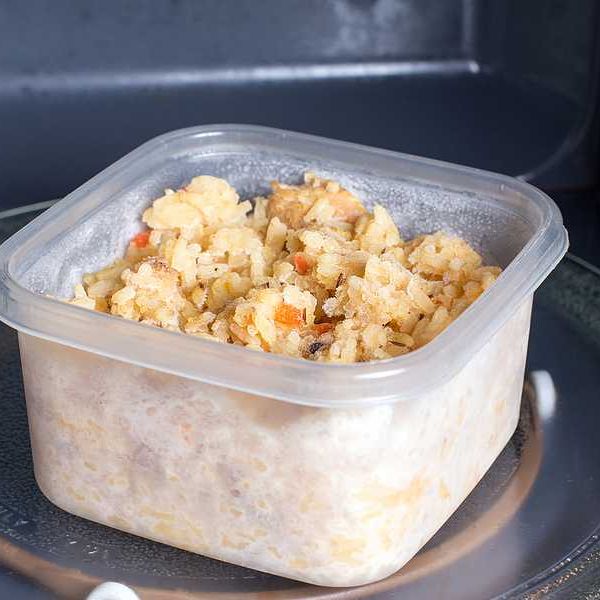 A plastic food container sitting in a microwave