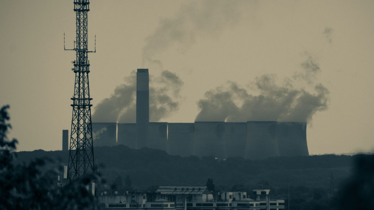 A power station with smoke billowing from towers