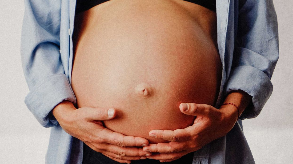 a pregnant woman holding her belly in her hands